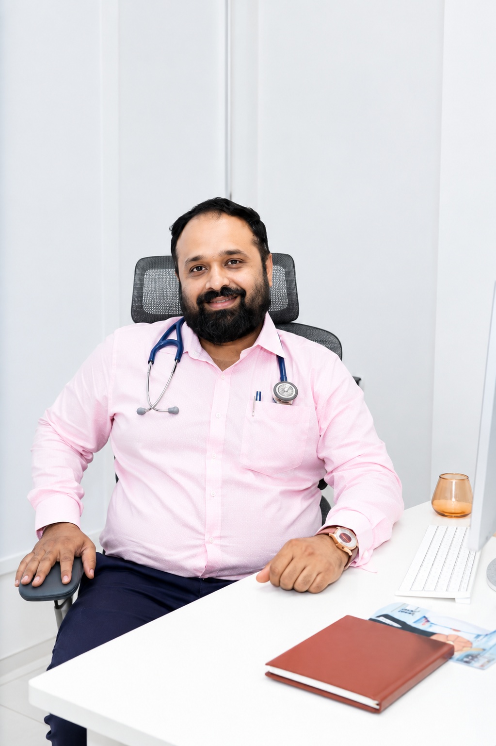 Dr. Suraj Kodak seated in his clinic